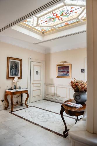 a living room with a skylight and a table at Al centro Luxury Home in Caserta