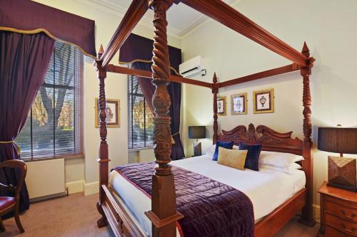 a bedroom with a four poster canopy bed at Twenty Nevern Square Hotel in London