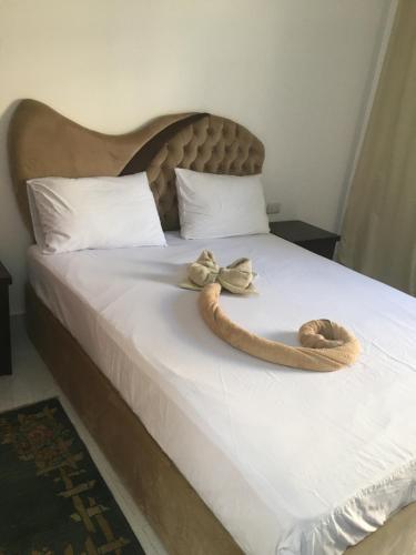a bed with two hats and a bow on it at fox house in Hurghada