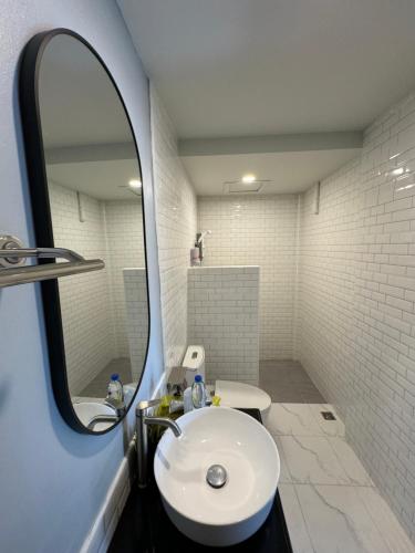 a bathroom with a sink and a mirror at S1 City Hotel Buriram in Buriram
