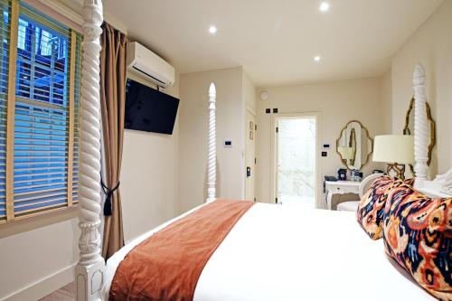 a bedroom with a white bed and a window at Twenty Nevern Square Hotel in London