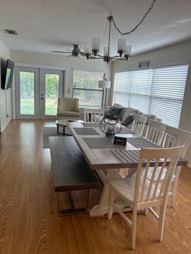 a living room with a dining room table and chairs at Delightful 3 Bdrm Home, Mins to Clearwater Beach in Clearwater
