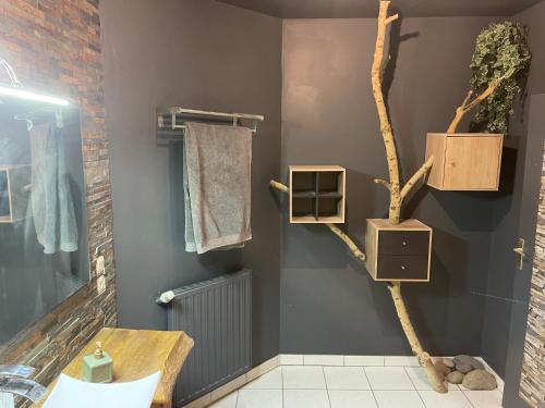 a bathroom with a tree branch shelf and a sink at Agréable bastide provençale avec piscine in Barcelonne