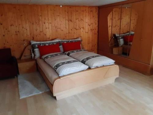 Mannried 2 12-Zimmerwohnung "Rustikal" في زويسمن: سرير كبير في غرفة بجدران خشبية
