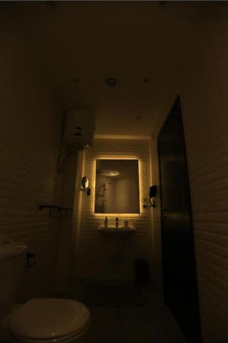 a bathroom with a white toilet and a window at Munir`s residence 2 in Cairo