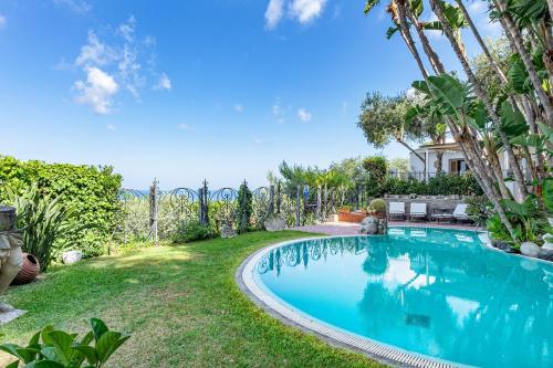 a swimming pool in the yard of a house at Villa Le Palme in Ischia