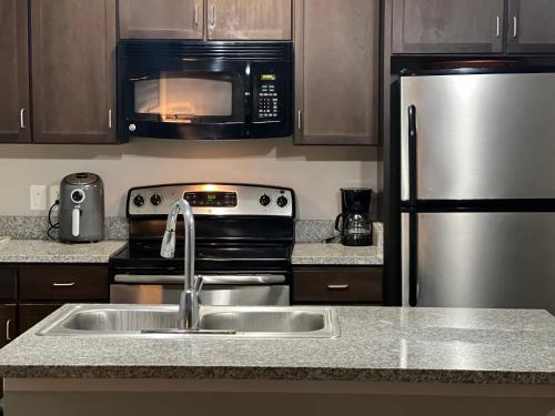a kitchen with a sink and a stainless steel refrigerator at Masterkeys Rentals LLC in Indianapolis