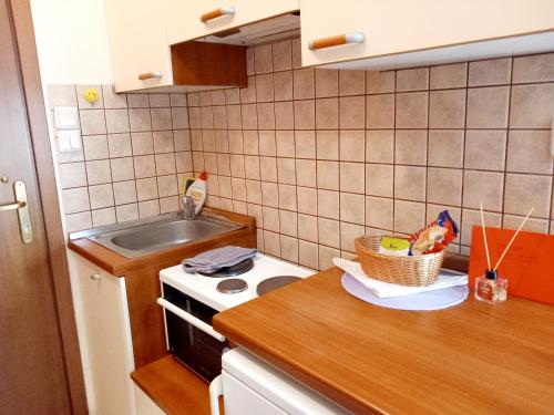 a kitchen with a sink and a counter with a bowl of food at Studio near University of Thessaly in Larisa