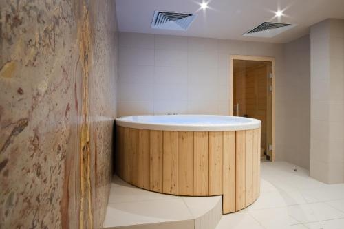 a bathroom with a round tub in a room at Mercure Saint-Lary in Saint-Lary-Soulan