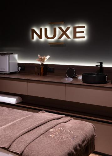 a bathroom with a nuke sign on a counter at Mercure Saint-Lary in Saint-Lary-Soulan