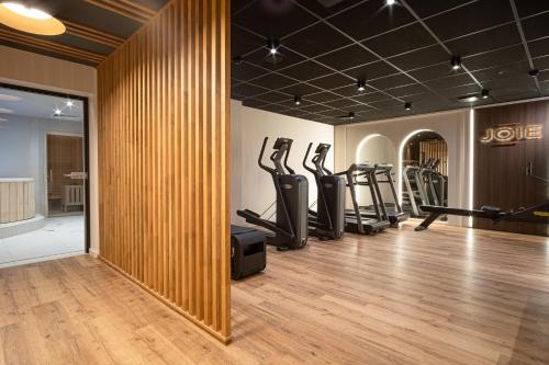 a gym with a row of treadmills and ellipticals at Mercure Saint-Lary in Saint-Lary-Soulan