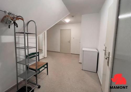 a hallway with a stair case and a room with a refrigerator at Schöne und geräumige Monteurwohnung in Bremen