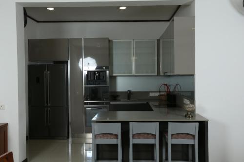 a kitchen with stainless steel appliances and a counter top at Eden Gardens Residence in Hokandara South