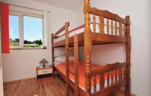 Etagenbett in einem Zimmer mit einer Leiter in der Unterkunft Stunning Apartment In Lokva Rogoznica With Wifi in Lokva Rogoznica