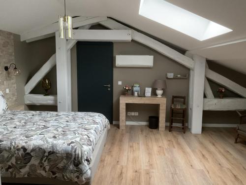 a bedroom with a bed and a loft with a skylight at LA MANSARDE in Aix-les-Bains