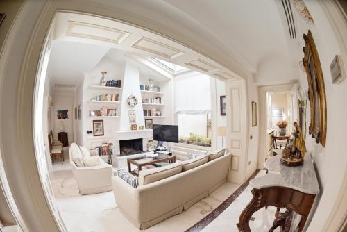 a living room with a large couch and a fireplace at Al centro Luxury Home in Caserta