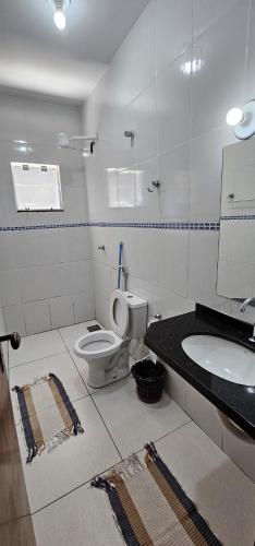 a bathroom with a toilet and a sink at Casa em Caldas Novas in Caldas Novas