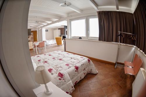 a bedroom with a bed and a table with a lamp at Al centro Luxury Home in Caserta