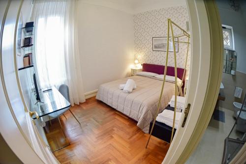 a small bedroom with a bed and a mirror at Al centro Luxury Home in Caserta