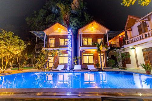 a swimming pool in front of a house at night at Tam Coc Green Mountain Homestay in Ninh Binh