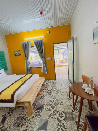 a bedroom with a large bed and a table at Ninh Chu 2 Hotel in Phan Rang