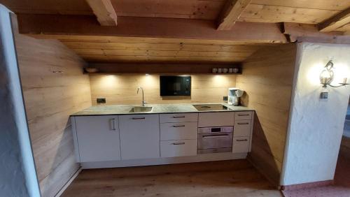 a kitchen with a sink and a microwave at Appartements Stadlerhof in Kramsach