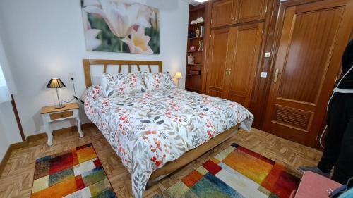 a bedroom with a bed and a wooden closet at Granada Home Center in Granada