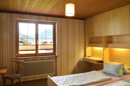a bedroom with a bed and a window at Haus Kohler in Häselgehr