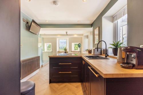 a kitchen with a counter top and a sink at Langdale Boulders, Ambleside, Fantastic views in Chapel Stile