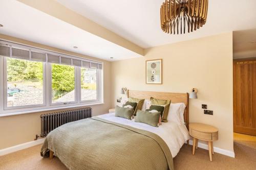 a bedroom with a large bed and a window at Langdale Boulders, Ambleside, Fantastic views in Chapel Stile