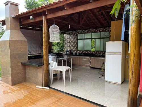 an outdoor kitchen with a refrigerator and a table at Casa para locação no período da Tecnoshow Comigo 2024 in Rio Verde