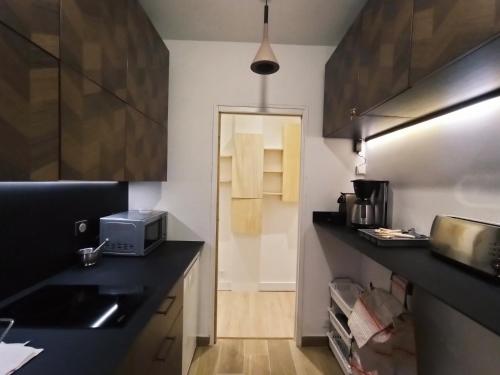 a kitchen with a sink and a microwave at Home Rental Service in Paris