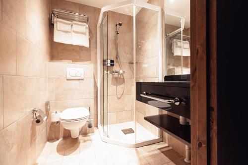 a bathroom with a toilet and a glass shower at Vestlia Resort in Geilo