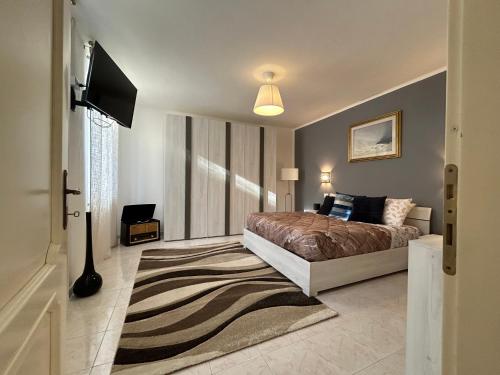 a bedroom with a bed and a flat screen tv at San Zeno Apartment in Verona