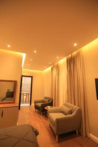 a living room with two couches and a television at Munir`s residence 2 in Cairo