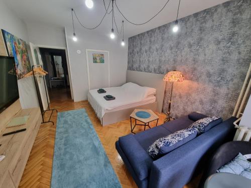 a living room with a couch and a bed at Apartment Vuksa in Novi Sad