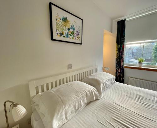 a bedroom with a bed and a picture on the wall at The Queen's Head Hotel in Buxton