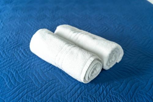 two rolls of white toilet paper on a bed at Guest House La Piazzetta in Capri