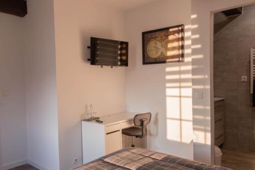 a bedroom with a bed and a sink and a shower at la chambre de l'ange in Saint-Herblain