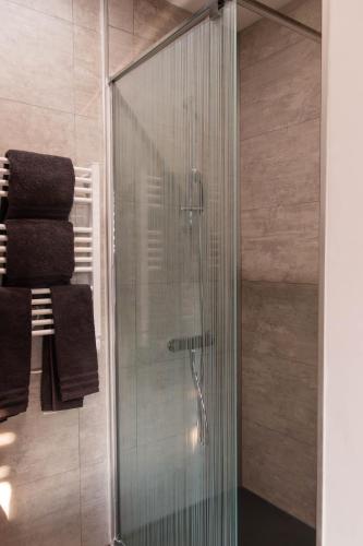 a glass shower in a bathroom with towels at la chambre de l'ange in Saint-Herblain