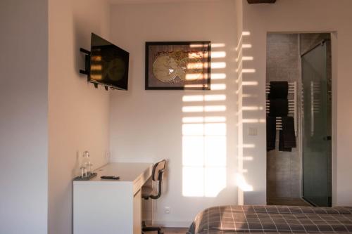 La salle de bains est pourvue d'un lavabo et d'une horloge murale. dans l'établissement la chambre de l'ange, à Saint-Herblain