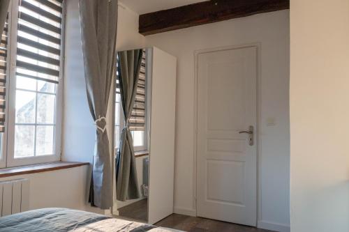 a bedroom with a door and a window at la chambre de l'ange in Saint-Herblain