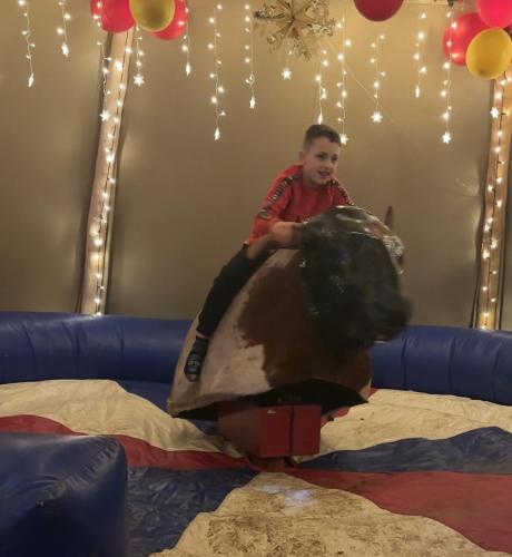 a young boy sitting on top of a stuffed animal at Burtree Country House, Tipi's, Treehouse & Lodge & house rooms with hot tubs in a private garden in Thirsk