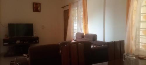 a living room with a couch and a television at Diamond PLaza in Malindi