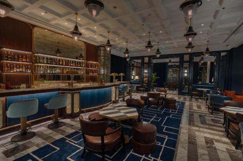 a lobby of a hotel with a bar and chairs at Waldorf Astoria Cairo Heliopolis in Cairo