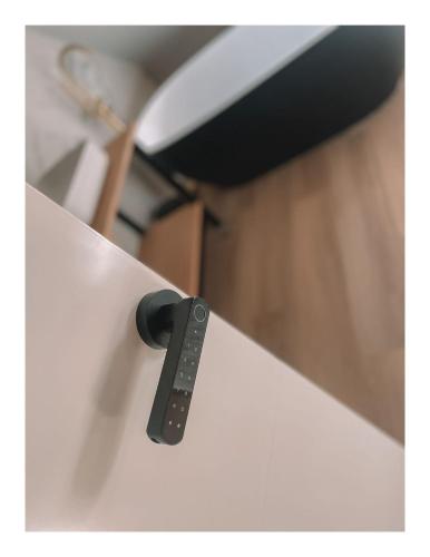 a black remote control sticking out of a white drawer at Slapen op Tholen in Tholen
