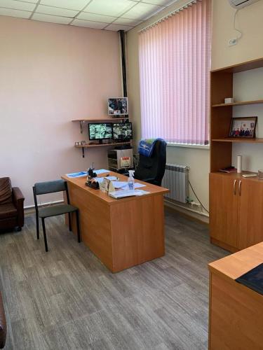 an office with a desk and a chair in a room at Фермерское хозяйство in Karagandy