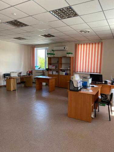 an empty office with desks and tables in a room at Фермерское хозяйство in Karagandy