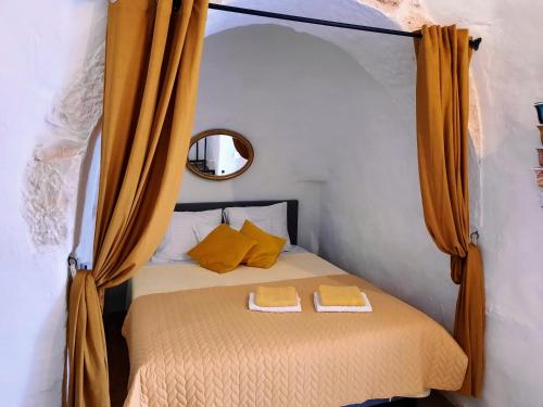 a bedroom with a bed with two towels on it at Casa Trullo Bianco: Casa Limone in Ceglie Messapica