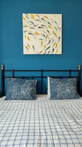 a bedroom with a bed with a blue wall at Torre de la Campana in Cartagena